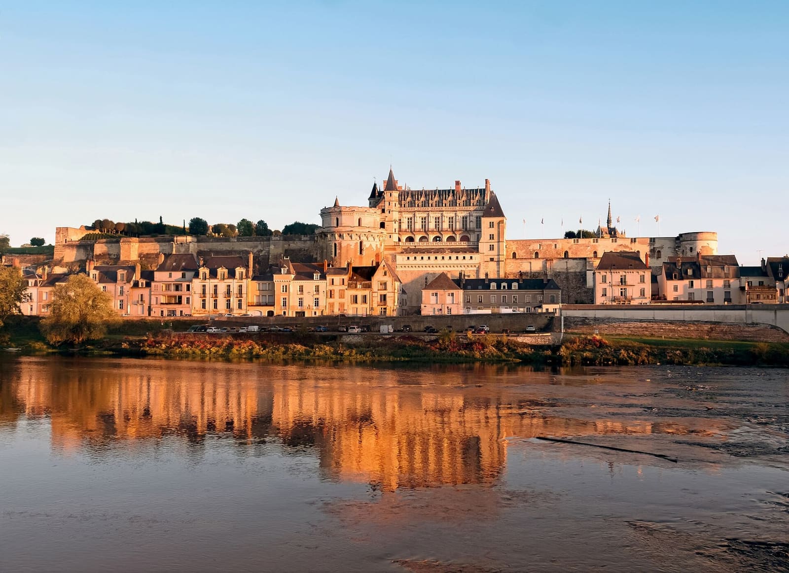 the Château royal d'Amboise lit by the last sun and reflected in the Loire
