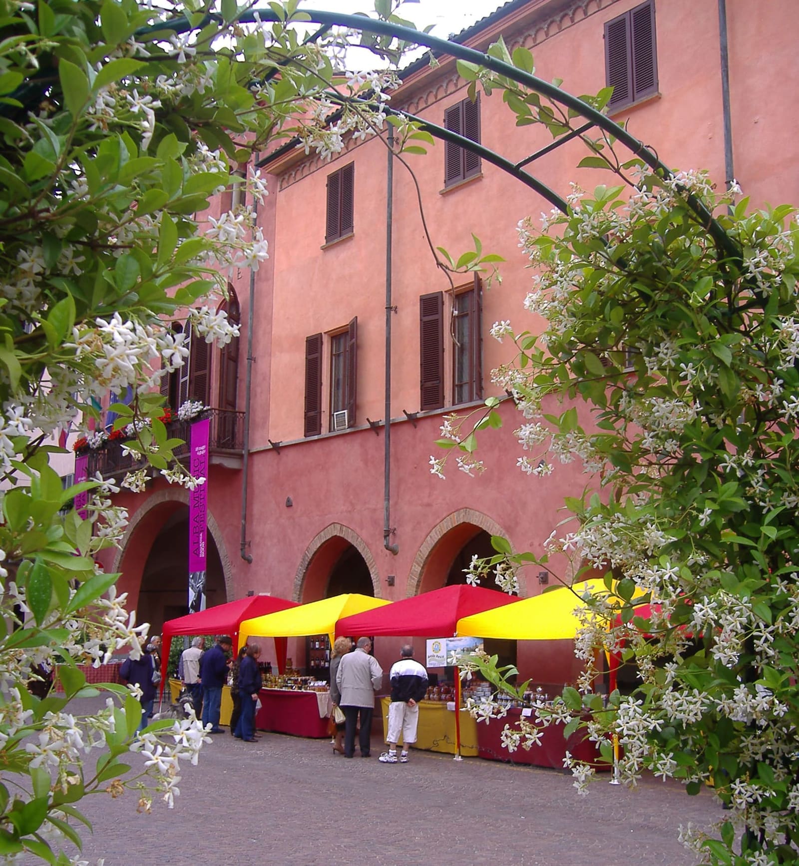 the stalls under the arcades of the town hall, in Piazza Risorgimento, during a spring festival