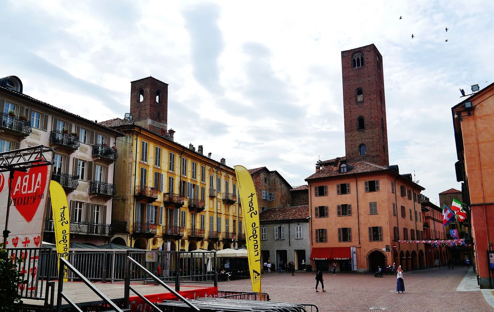 Piazza Risorgimento, the cathedral square, with the towers above the houses and the banners of the Fair