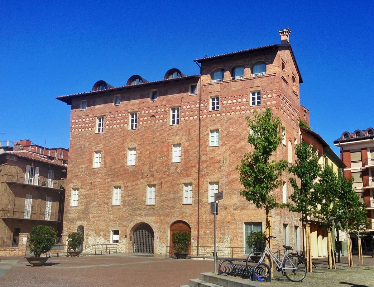 Piazza Pertinace, with the brick palazzo and its trees