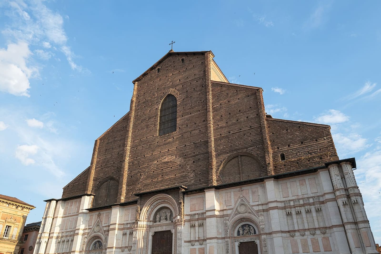 la facciata di San Petronio, con la parte bassa in marmo e quella alta rimasta in mattoni