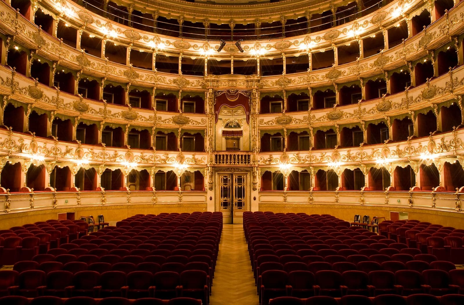 la sala a ferro di cavallo del Teatro Grande, con i palchi dorati e il palcoscenico