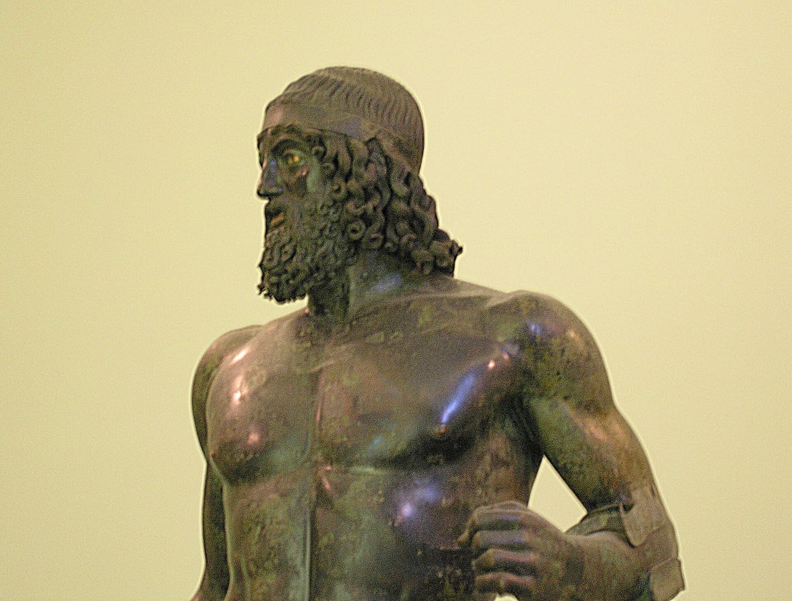 il Bronzo A, la testa con la barba a riccioli e la spalla