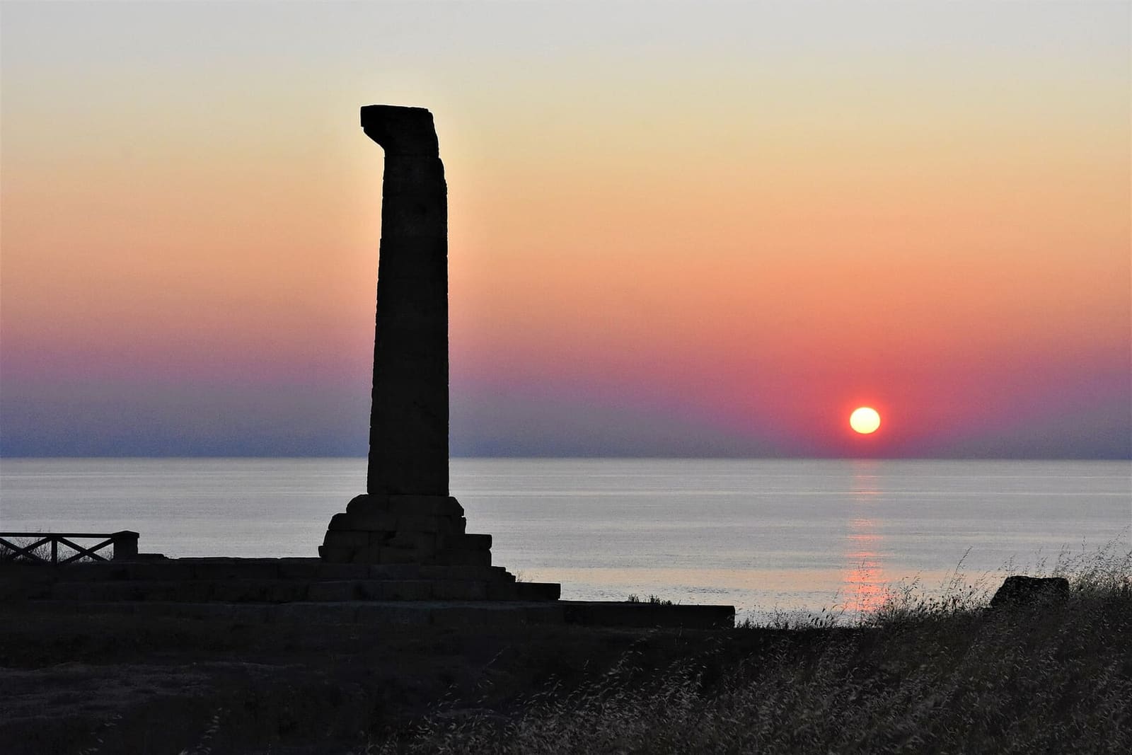 the column against the light at dawn, over the Ionian Sea