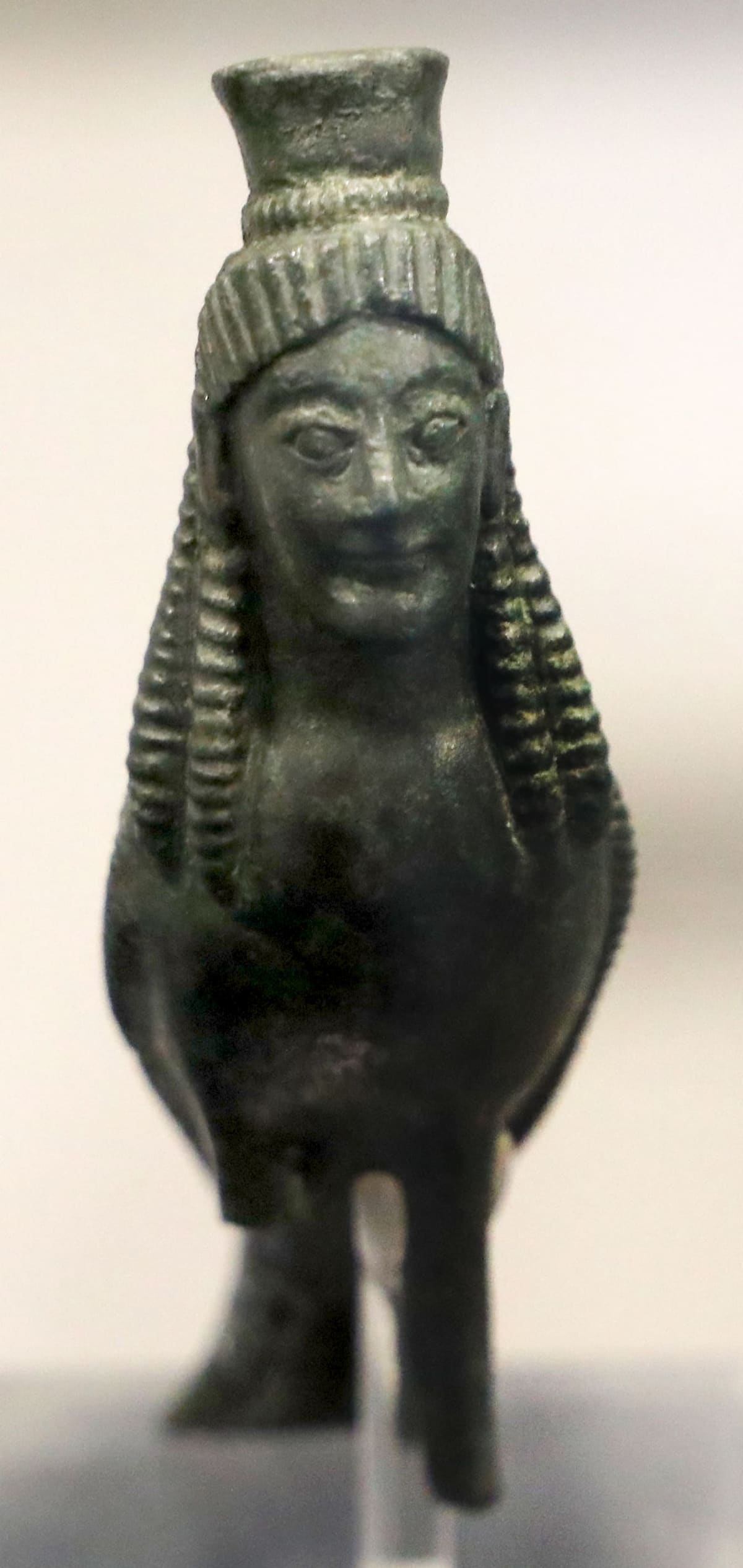 a bronze siren, from the sanctuary