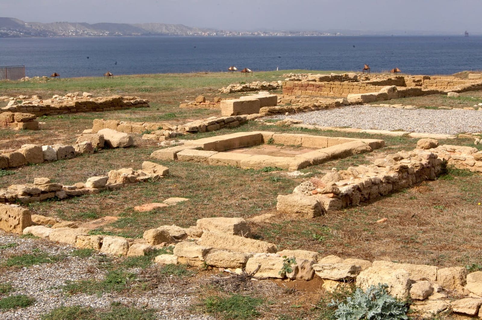 the remains of a house of the Roman colony, with the sea and Crotone in the distance