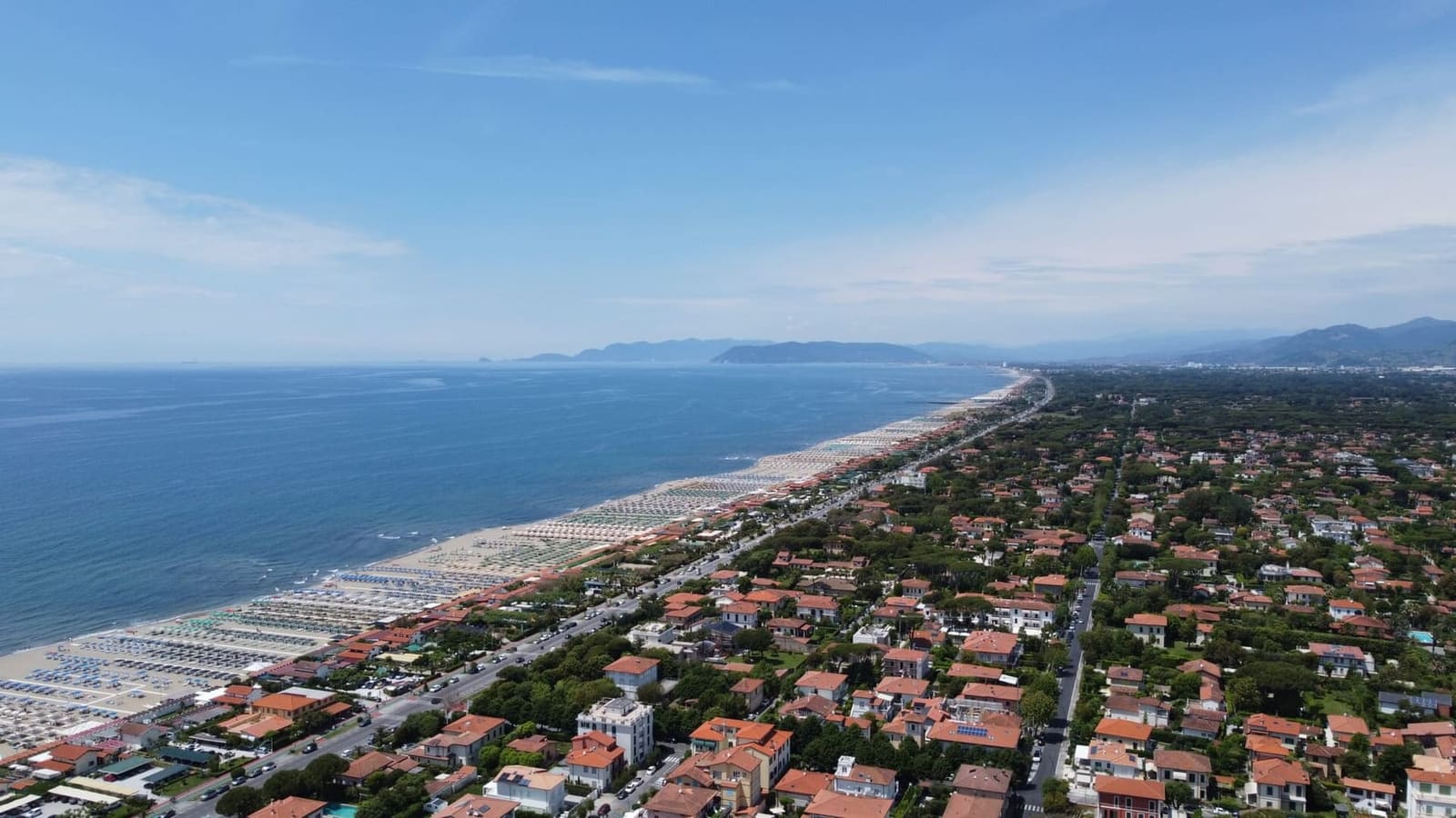 der lange Strand von Forte dei Marmi von oben, nach Norden gesehen, mit den Vorgebirgen Liguriens im Hintergrund