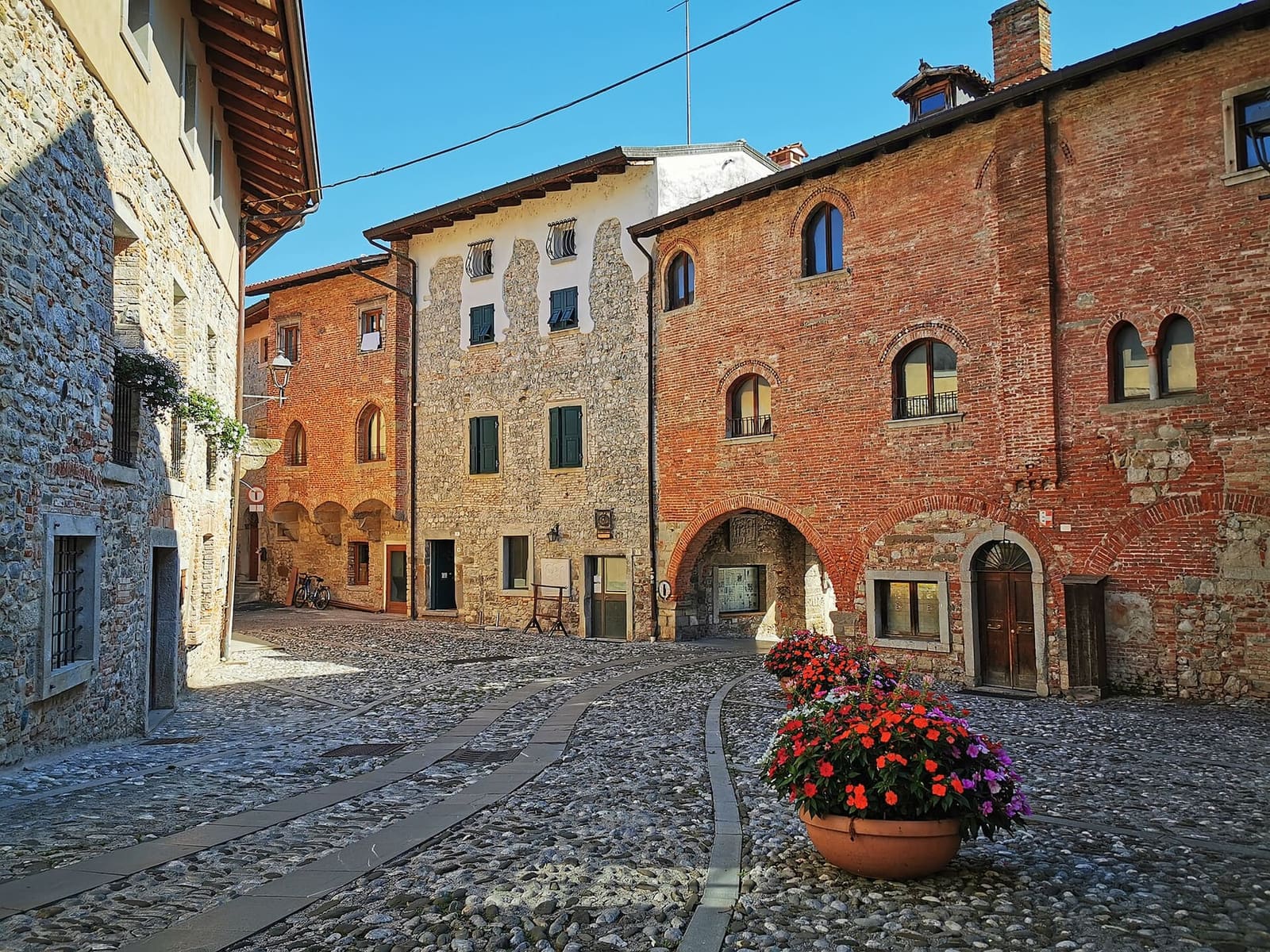 case in pietra e mattoni affacciate su una piazzetta acciottolata del centro storico
