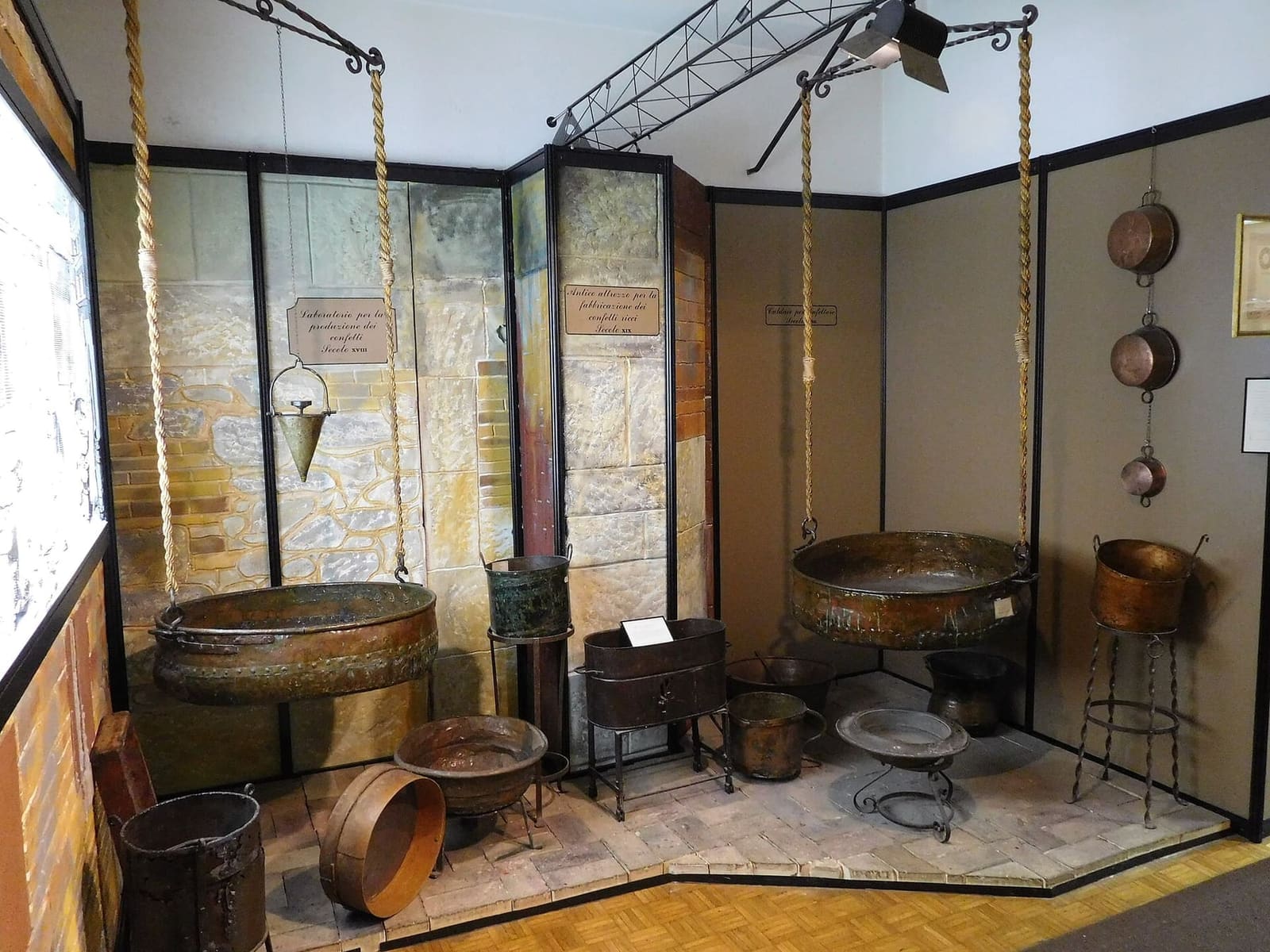 the copper pans hanging from ropes, which were swung by hand to coat the almonds in sugar