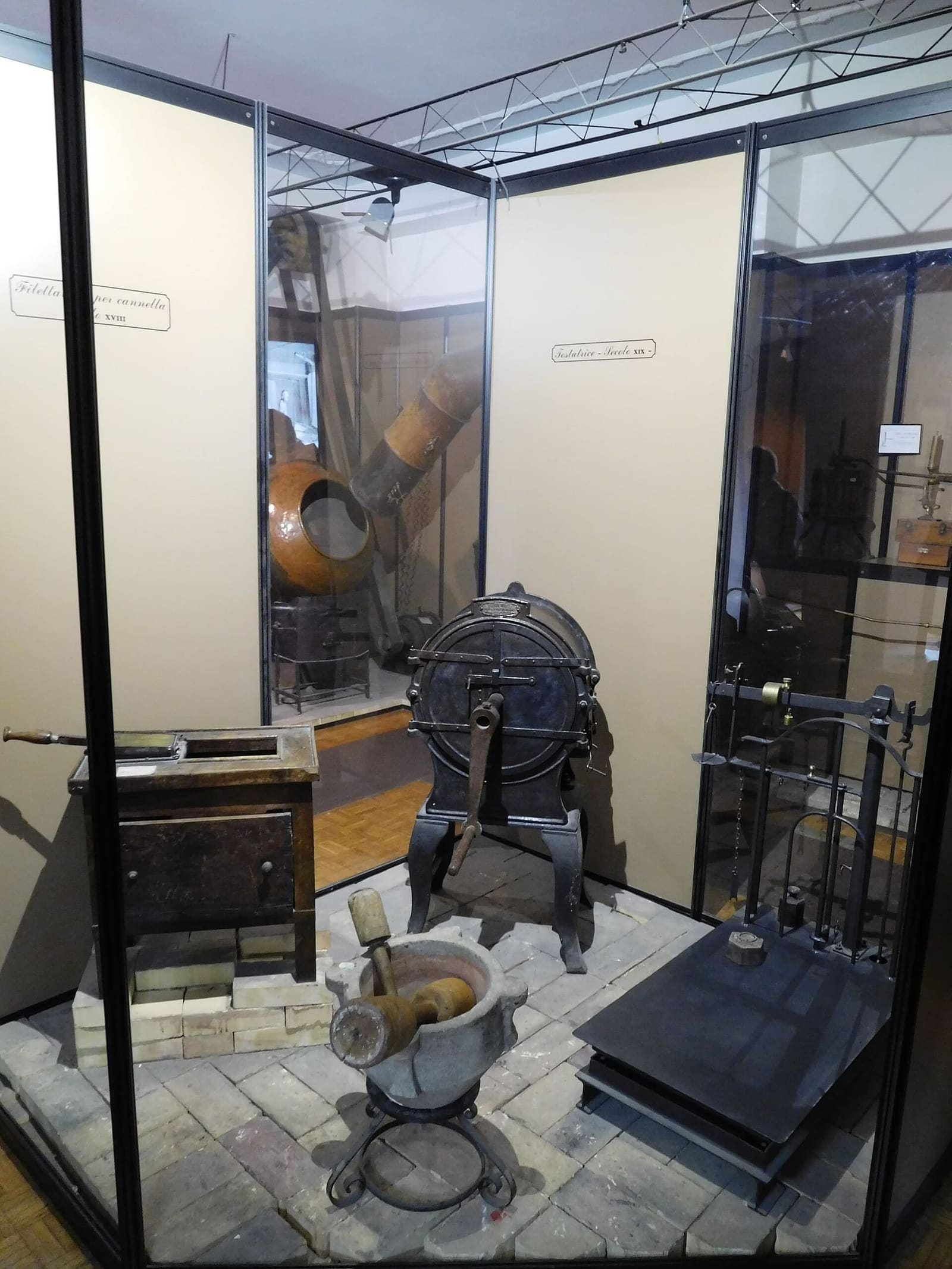 antique machines and tools for making confetti in the display cases of the Pelino museum