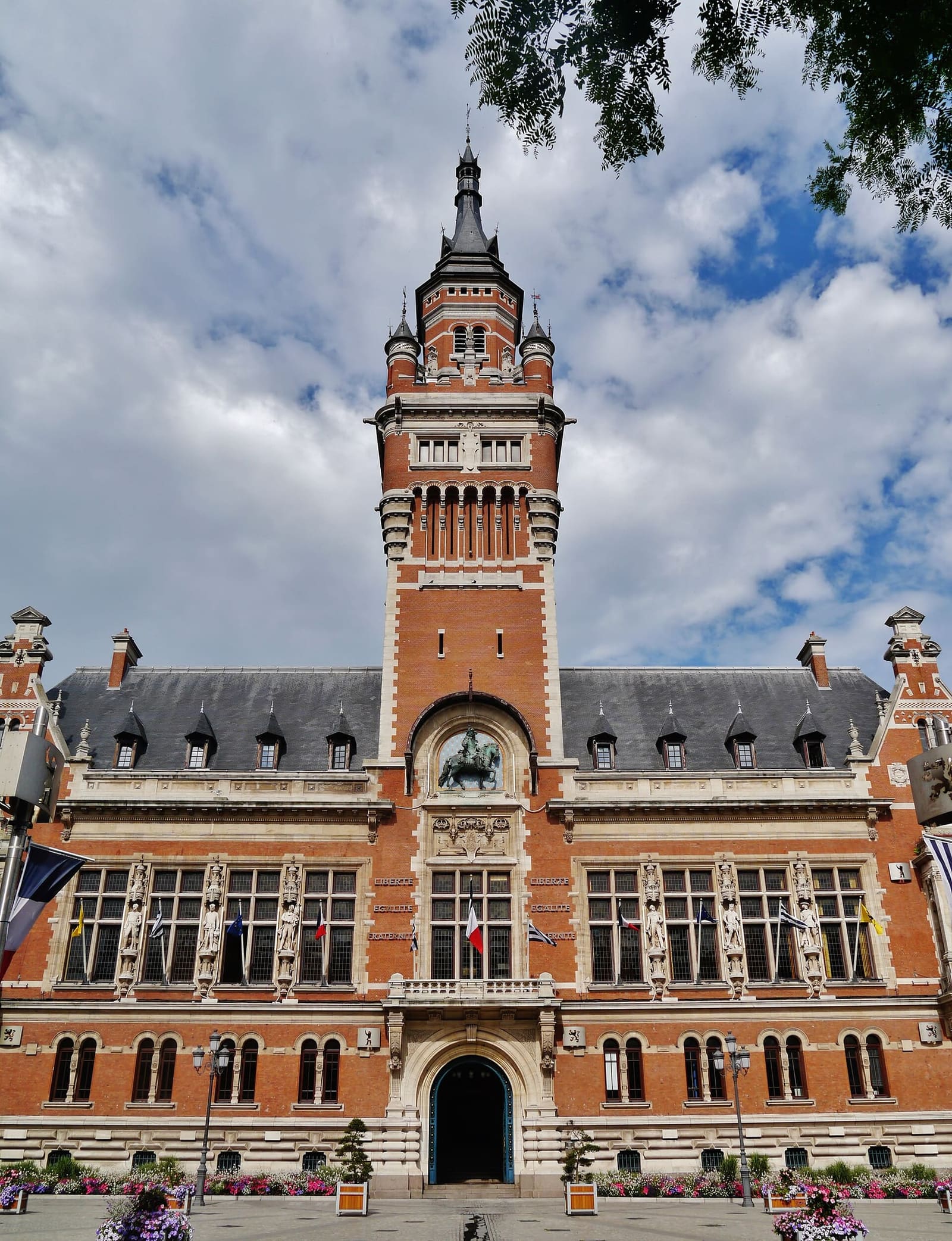 the brick and stone Hôtel de ville, with its belfry and Louis XIV on horseback above the central window