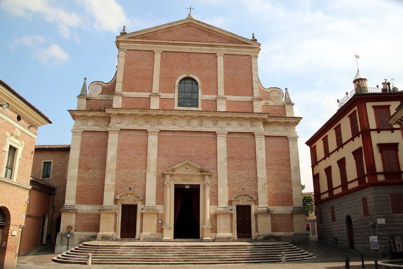 la facciata della cattedrale di San Venanzio, in mattoni e pietra chiara, con la scalinata davanti