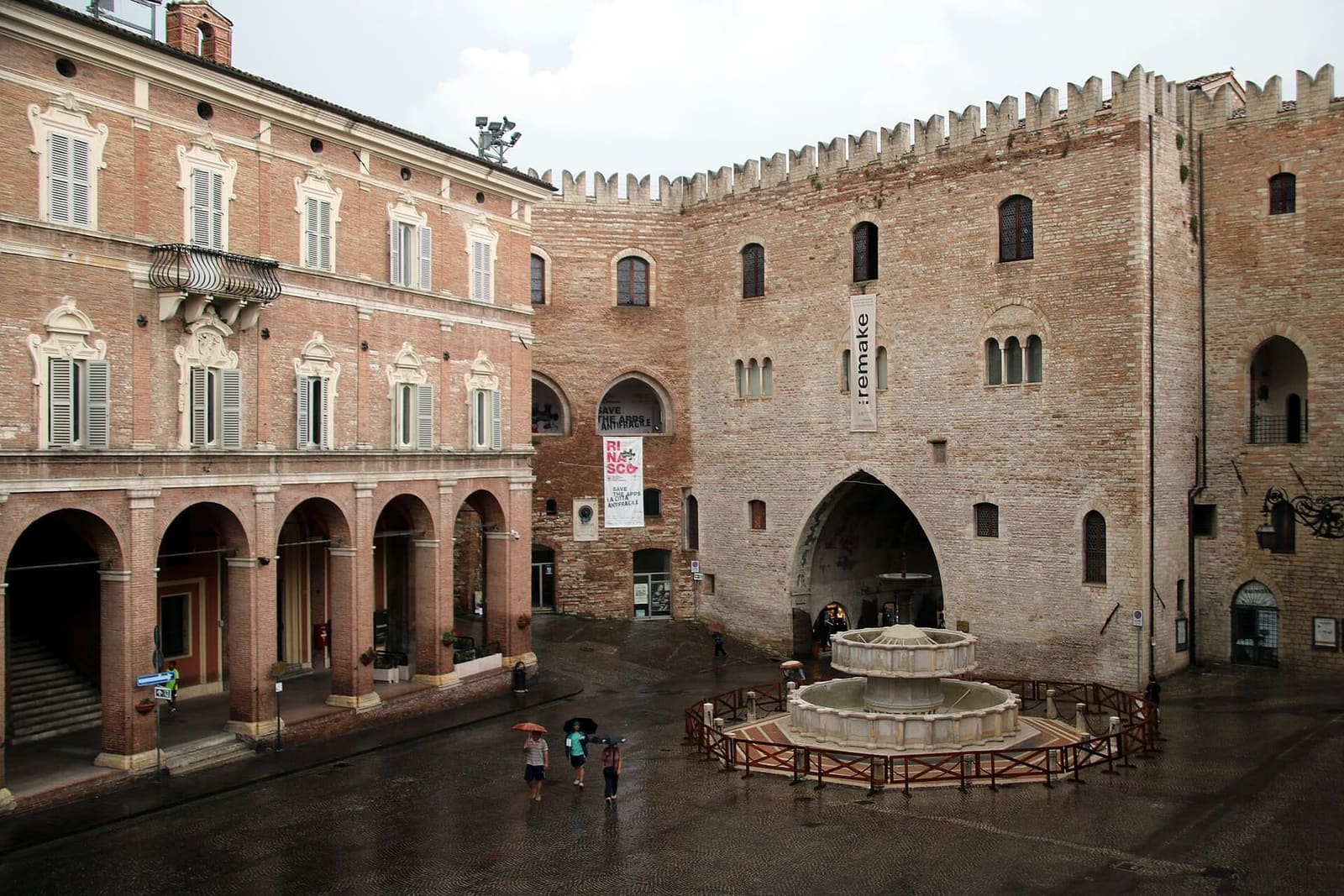piazza del Comune vista dall'alto, con la fontana Sturinalto in mezzo, il Palazzo del Podestà in fondo e i portici a sinistra