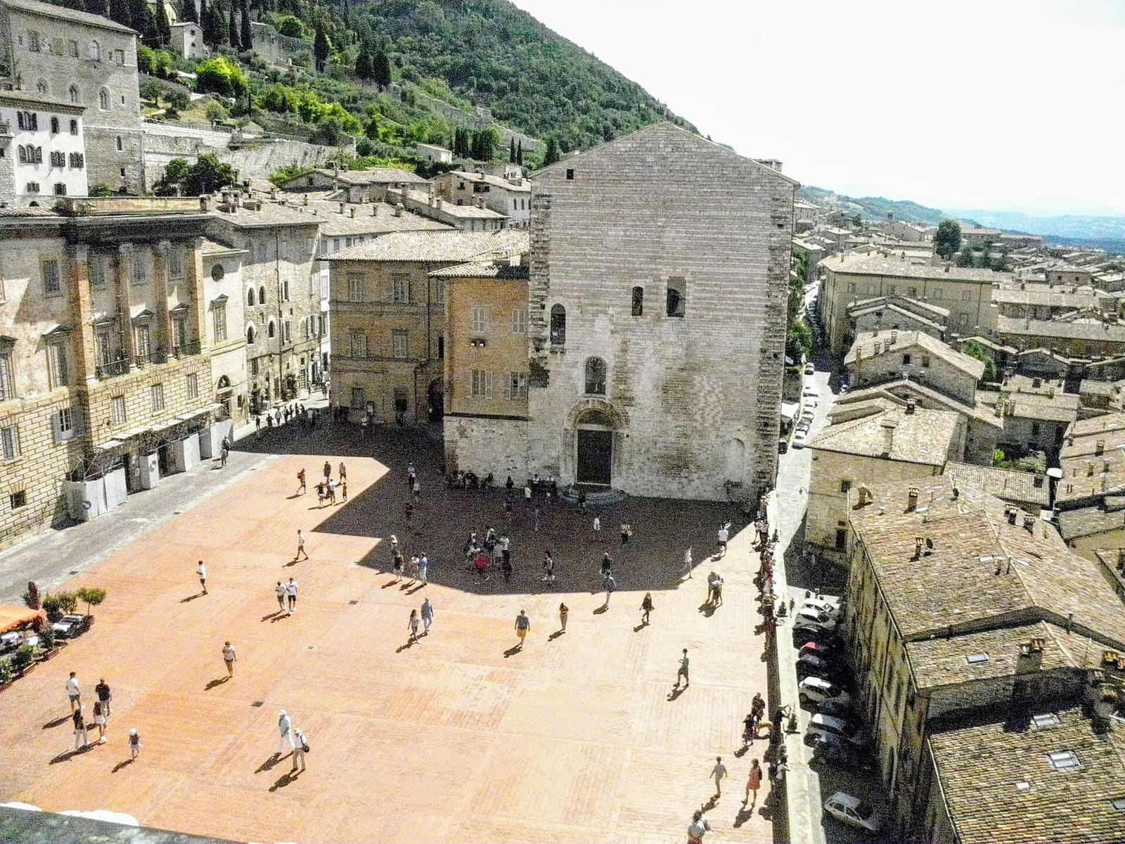 piazza Grande vista dall'alto del Palazzo dei Consoli, con il Palazzo Pretorio e i tetti della città bassa oltre il parapetto