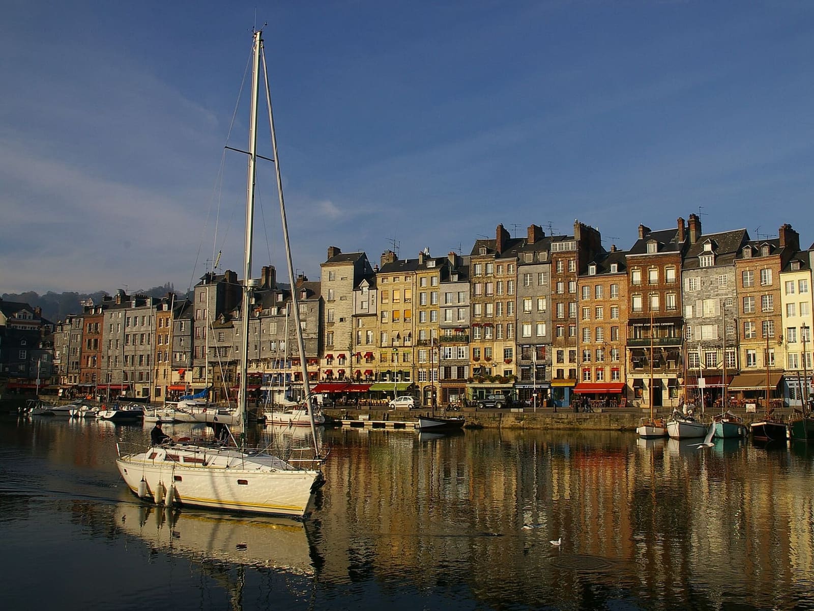 le case del quai Sainte-Catherine nella luce calda del mattino, riflesse nell'acqua del Vieux Bassin, a novembre
