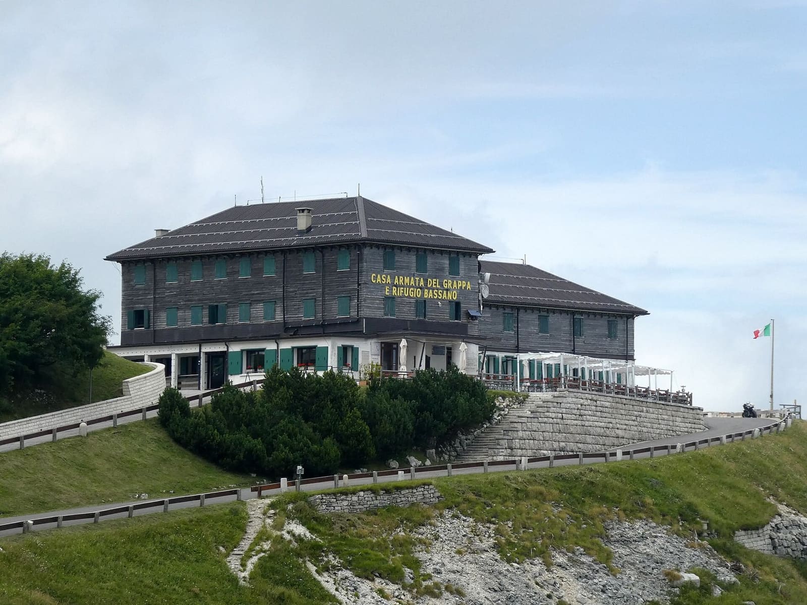 la Casa Armata e il rifugio Bassano accanto al Sacrario, in una giornata di nuvole a luglio