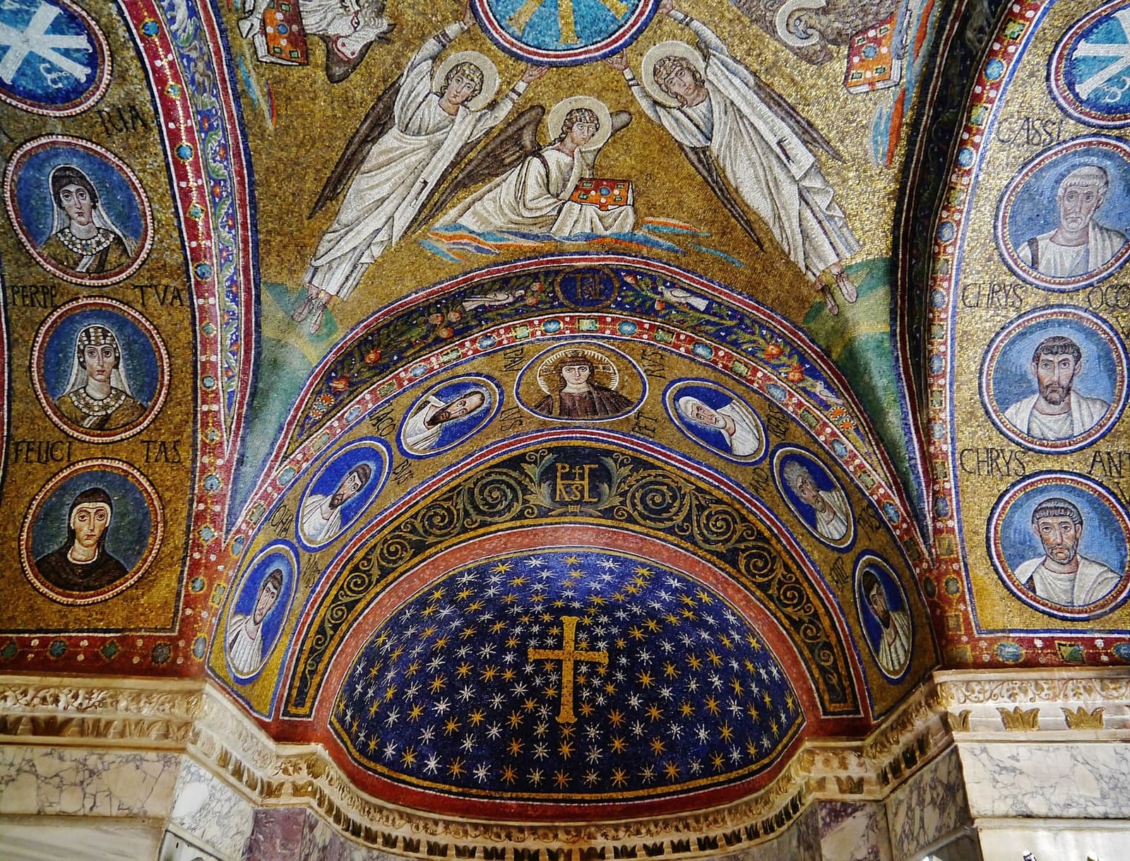 the apse of the Chapel of Sant'Andrea in the Museo Arcivescovile, with the gold cross in the starry sky and the medallions of the saints