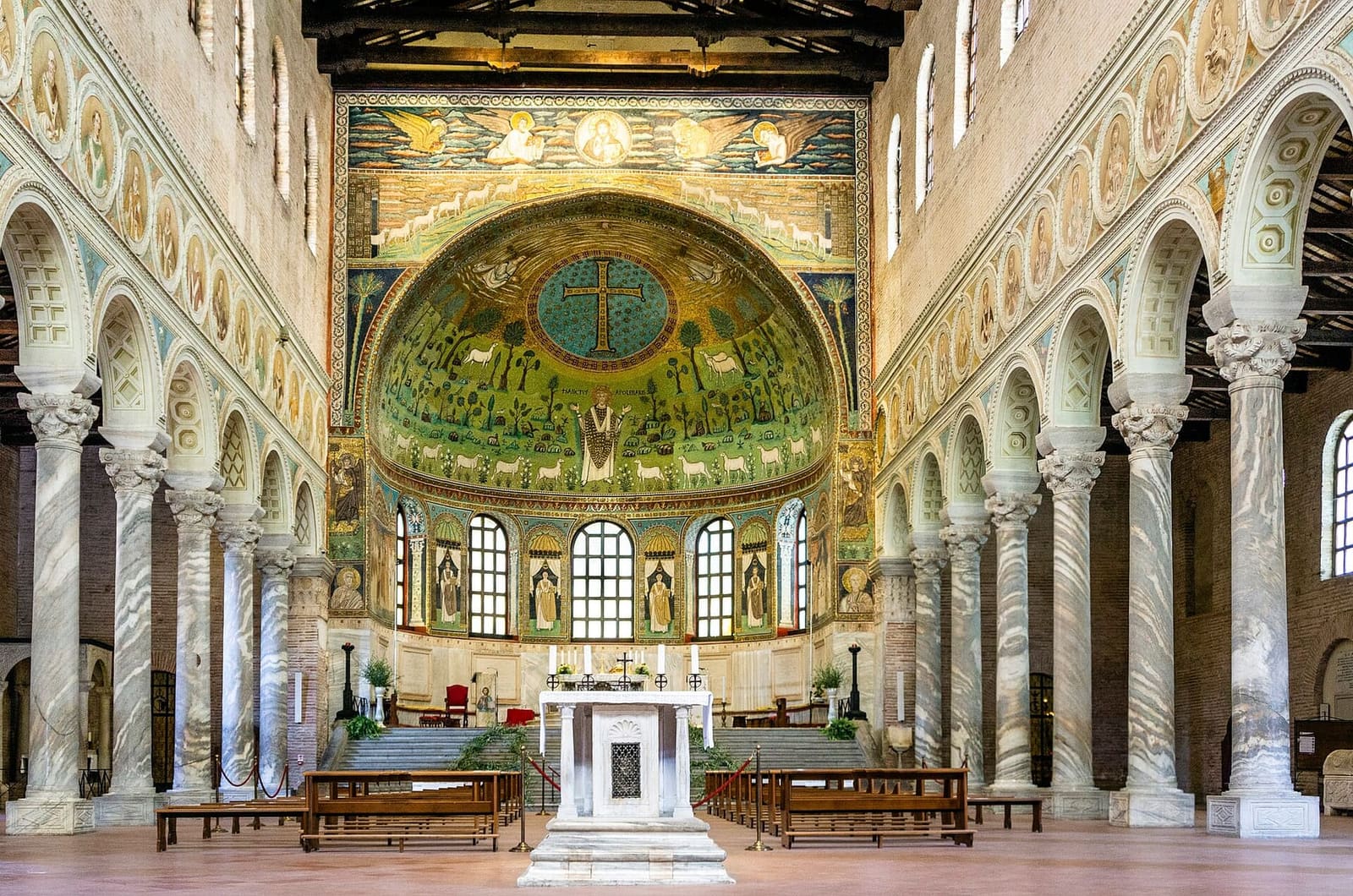 the nave of Sant'Apollinare in Classe with the veined marble columns leading to the apse