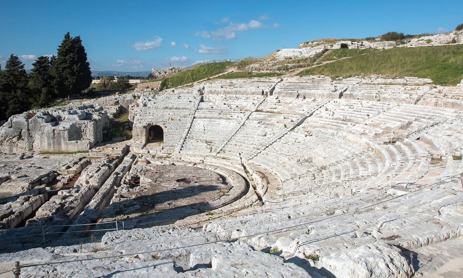 la cavea del Teatro greco tagliata nel colle, sotto un cielo sereno