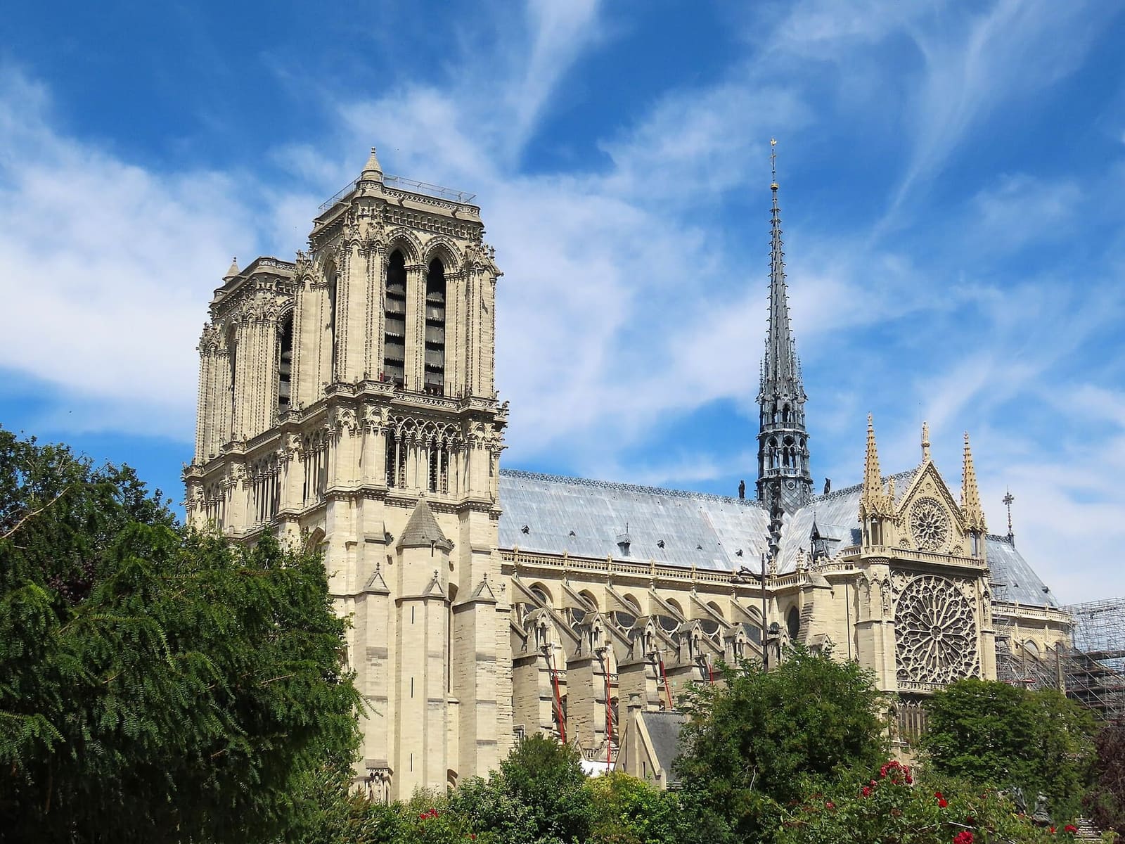 the side of Notre-Dame with the rebuilt spire and the south rose window, from Square René-Viviani