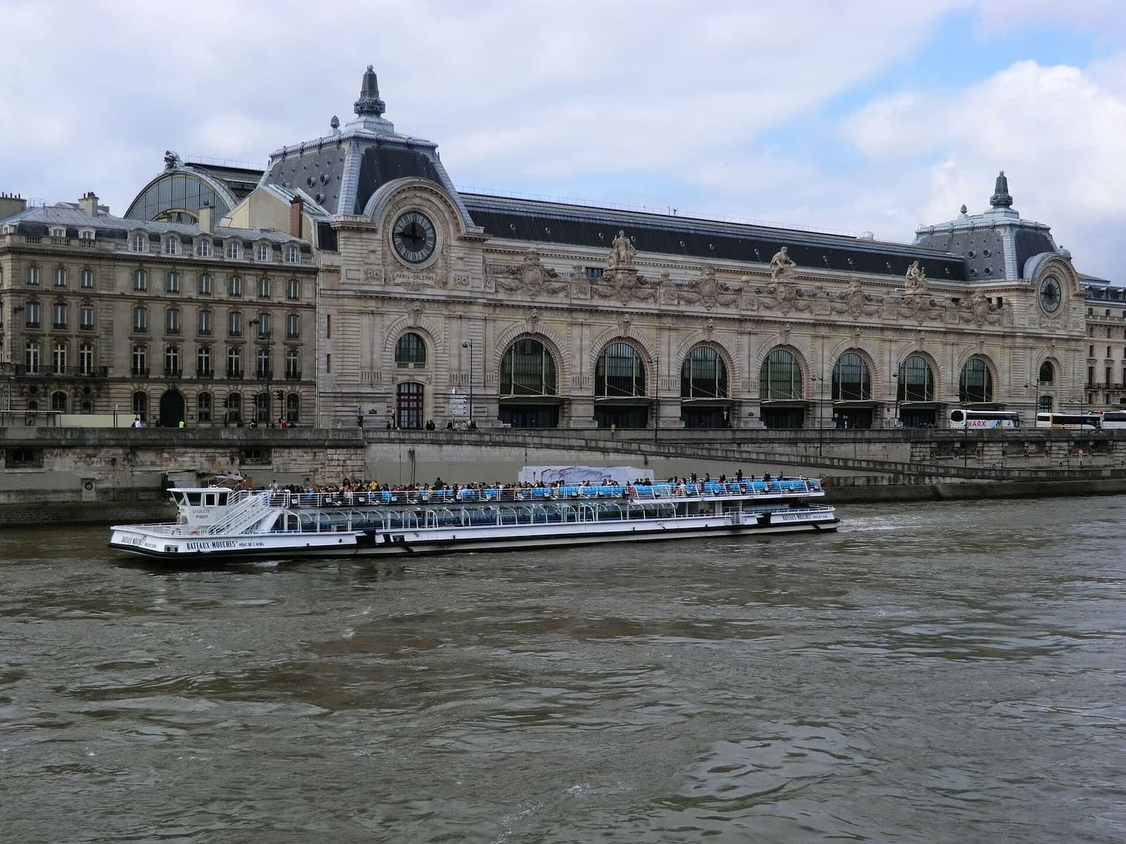 the Musée d'Orsay, the old railway station, on the Seine with a boat passing in front
