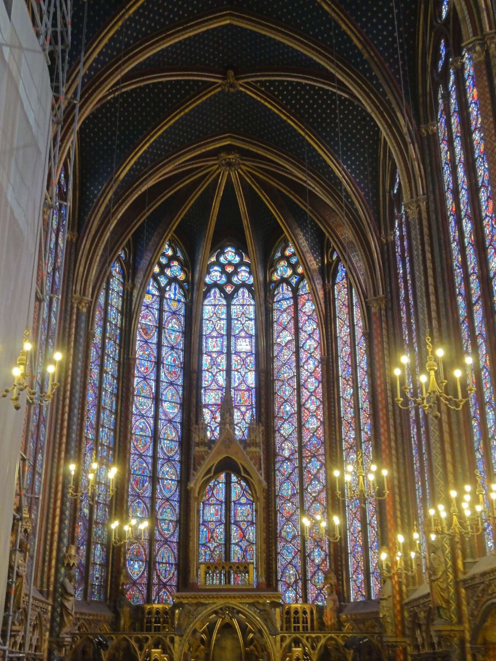 the upper chapel of the Sainte-Chapelle looking towards the apse, between the stained glass and the chandeliers