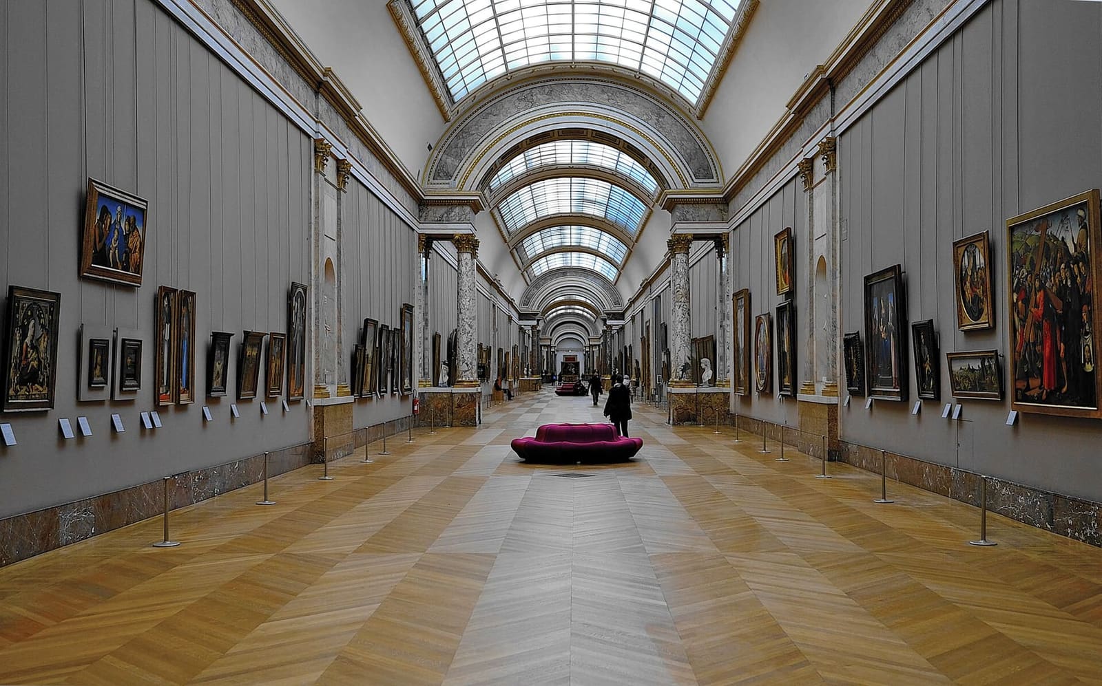 the Grande Galerie of the Louvre, with paintings on the walls and light from the skylight