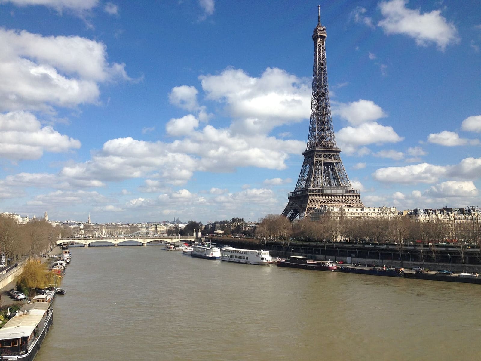the Eiffel Tower on the bank of the Seine, with moored barges