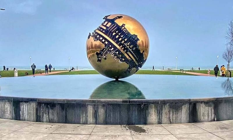 la Sfera Grande di Arnaldo Pomodoro nella vasca sul lungomare, con il mare alle spalle