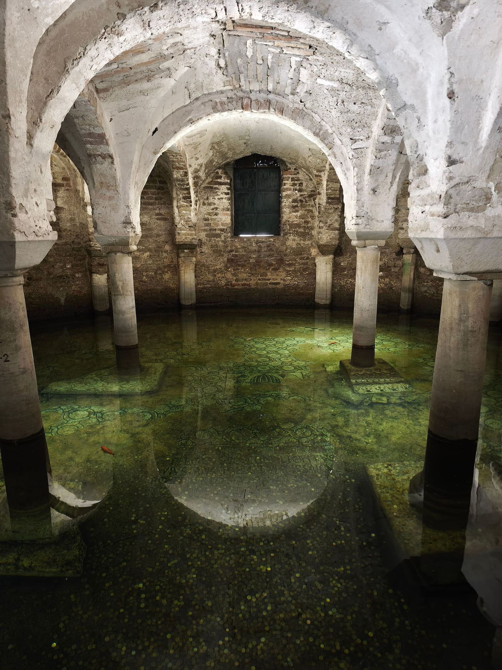 die überflutete Krypta unter dem Altar von San Francesco, mit dem Wasser über dem Mosaikboden