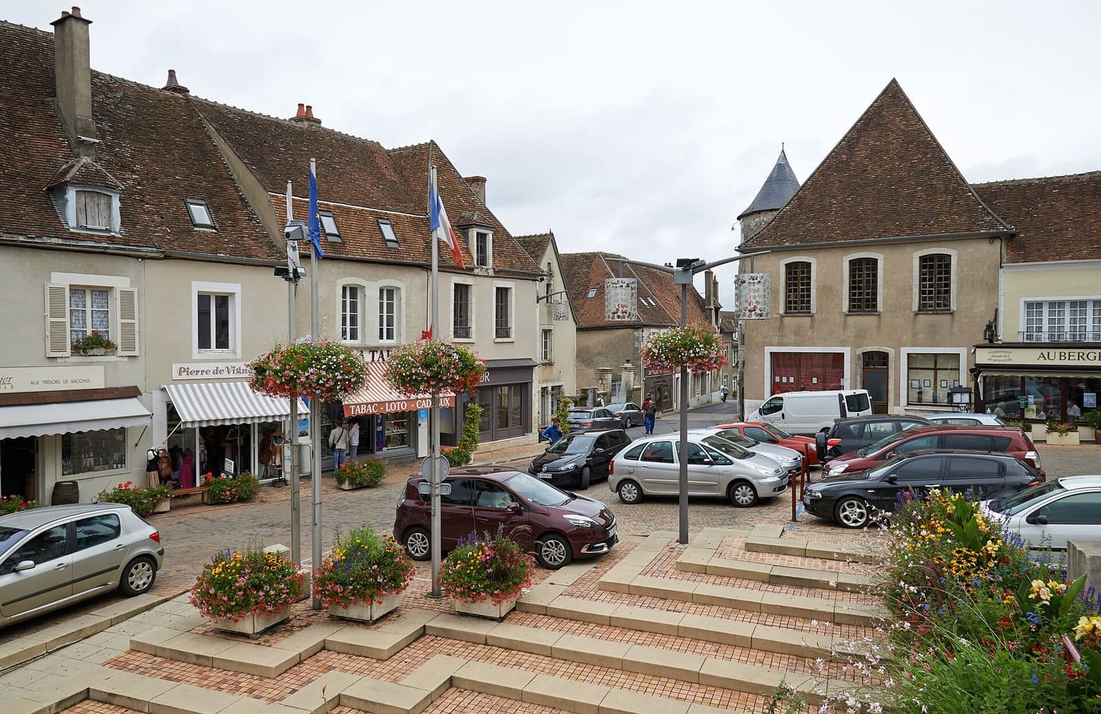 la Nouvelle Place con le aiuole fiorite e i gradini, ad agosto