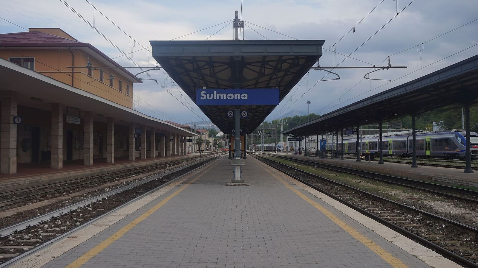the tracks and platform canopies of Sulmona station, the meeting point for passengers