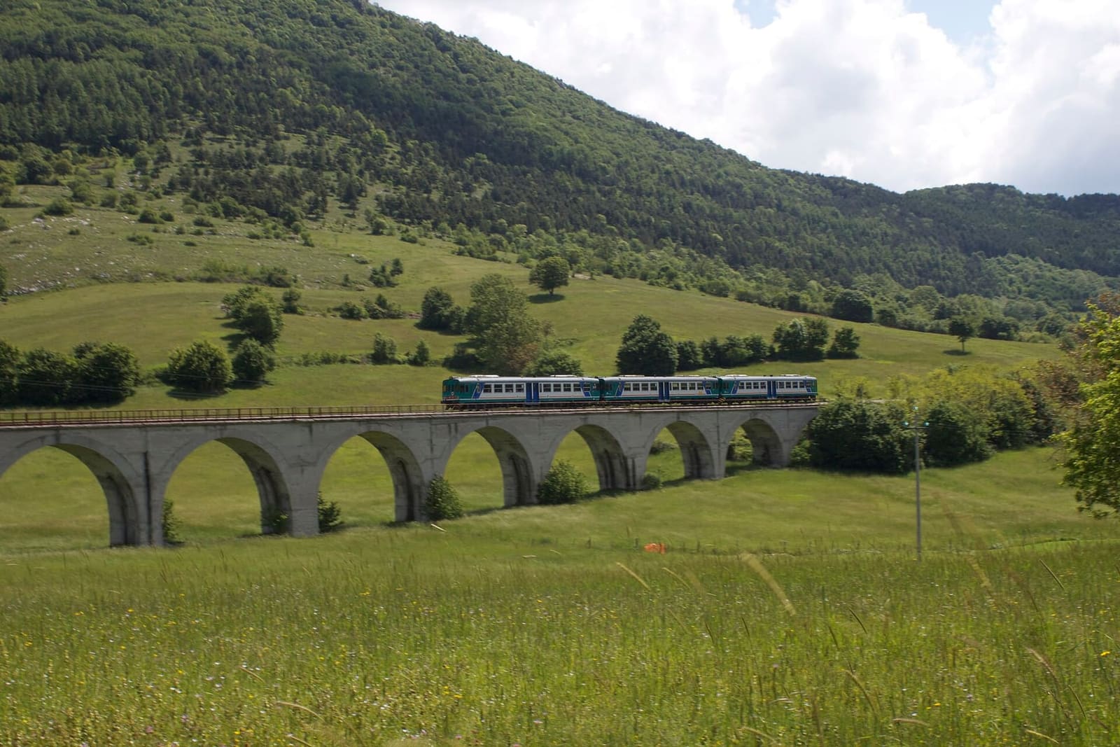 a tourist train on a viaduct of the Sulmona-Isernia railway, in May 2012