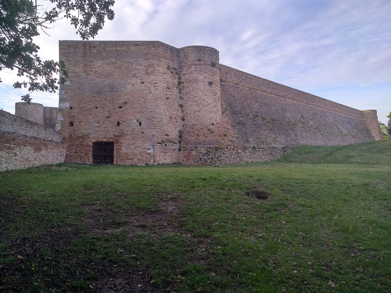 la Fortezza Albornoz, con le mura di mattoni fra gli alberi del parco